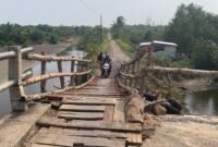Warga secera  bergantian melawati jembatan teluk sapang.